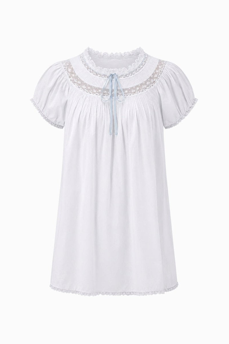Flat front view of Kouvr white romantic nightgown dress showing intricate chest lace and pastel blue bow.