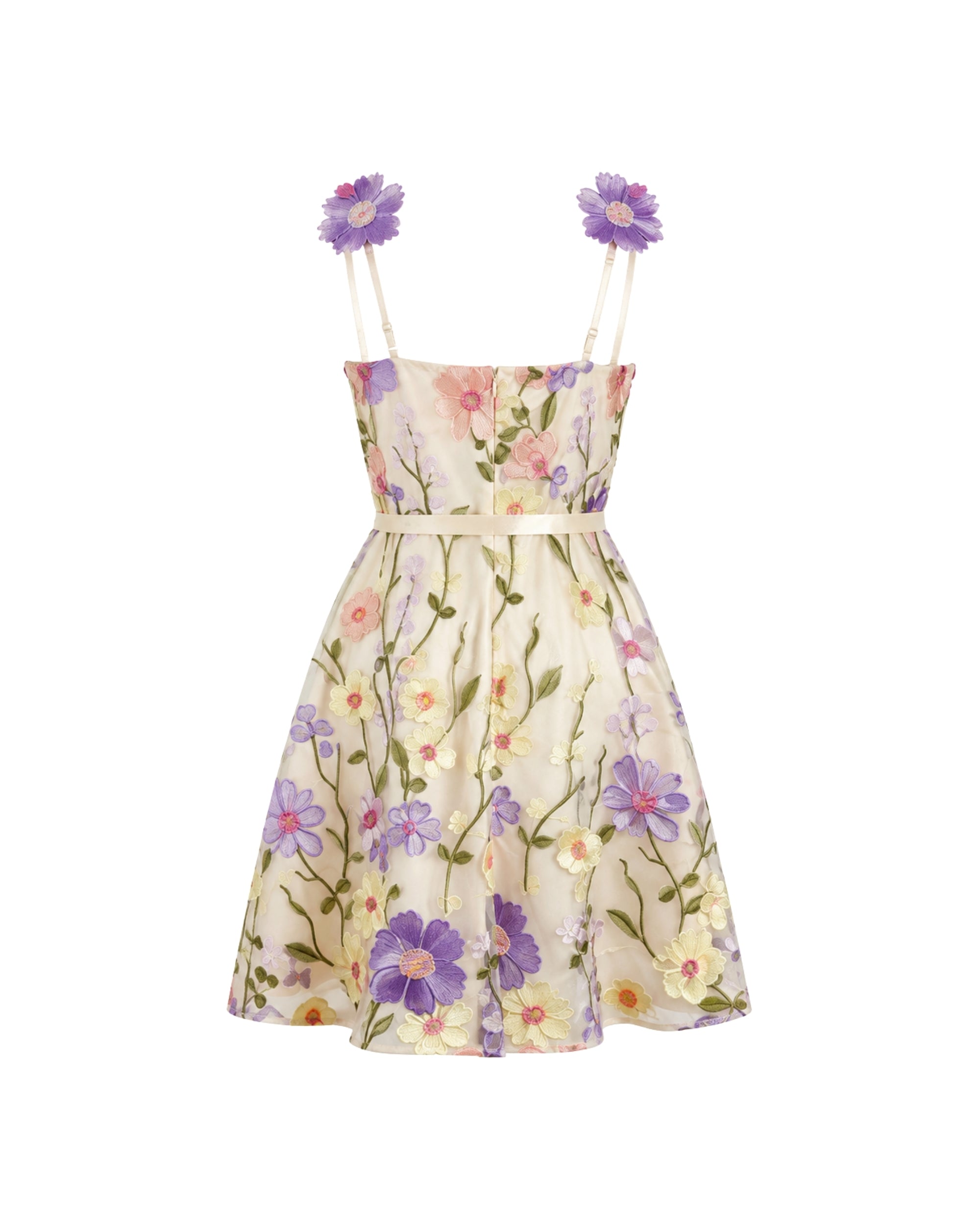 A sleeveless cream-colored mini dress with a vibrant floral print in purple, pink, and green, featuring thin shoulder straps adorned with purple flower embellishments.