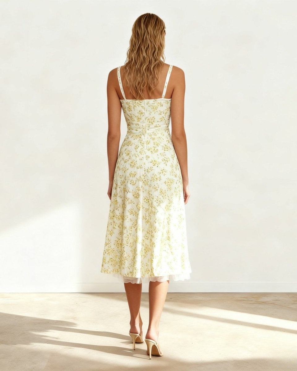 Back view of the white floral dress highlighting the smocked back panel and delicate lace shoulder.