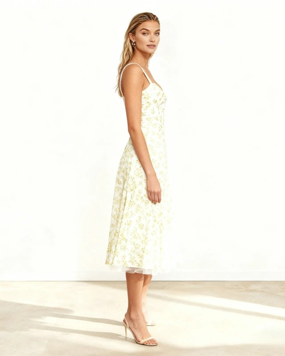 Side profile of a model in the white floral A-line midi dress, showcasing its fit and flare silhouette.