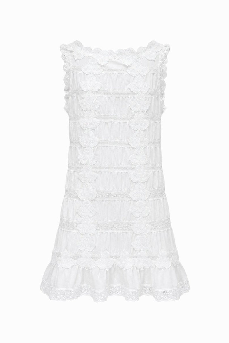 Detailed back view of Kouvr white lace summer mini dress highlighting tiered construction and scalloped edges
