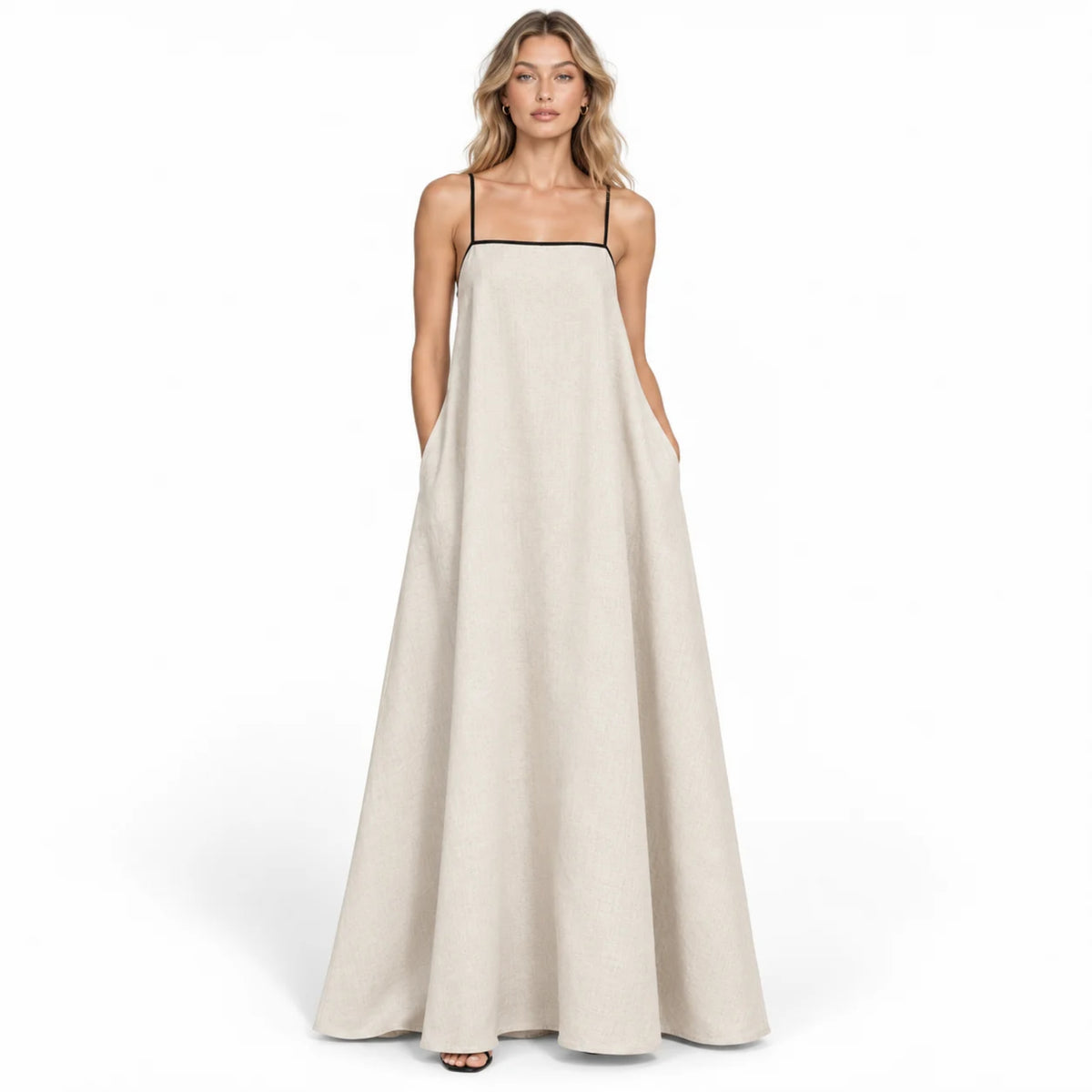 Front studio view of a woman wearing the beige flowy linen summer maxi slip dress featuring black contrast trim and a square neckline.