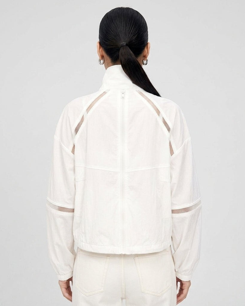 Back view of the Kouvr white lightweight windbreaker jacket highlighting sheer mesh ventilation panels