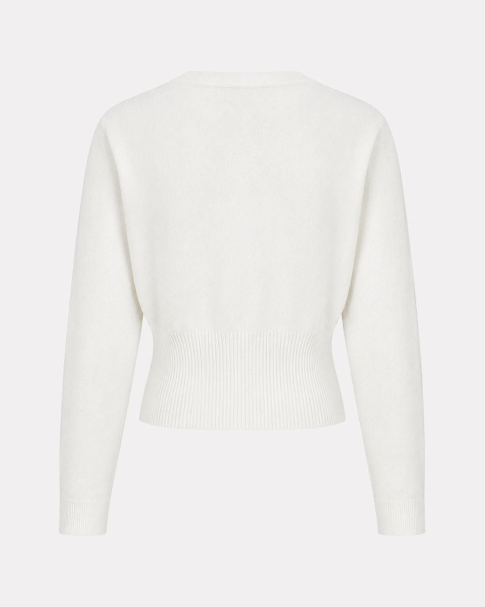 A cream-colored knit sweater with long sleeves and a ribbed hem, shown from the back on a light gray background.