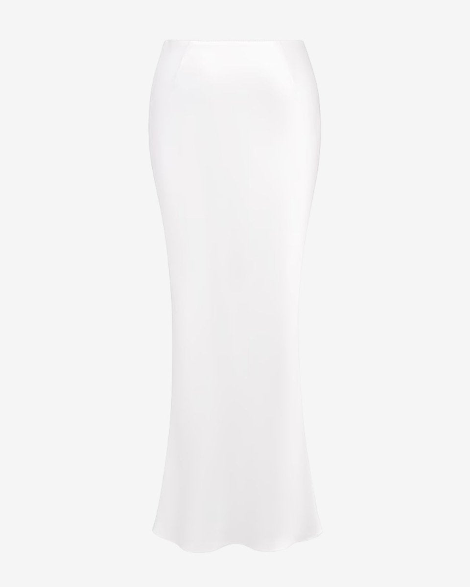 Angled product view of the long white satin slip skirt, highlighting the fabric's luminous texture and quality.