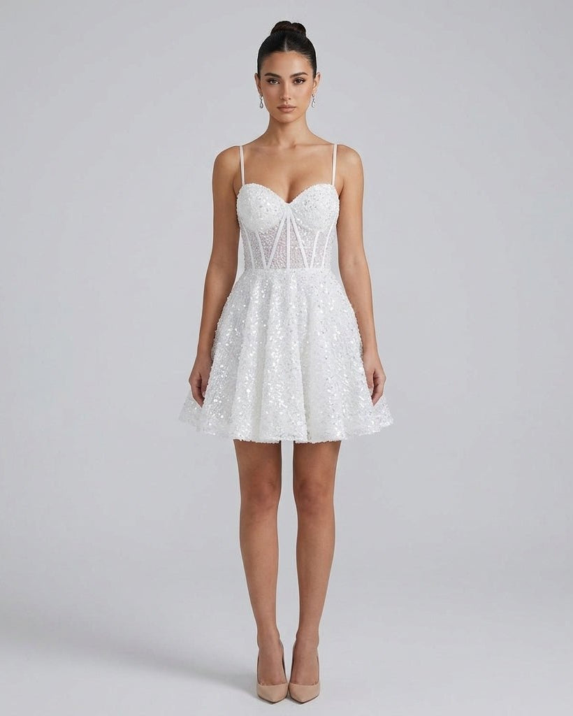 Woman wearing white sequin corset mini dress with sweetheart neckline and flared skater skirt