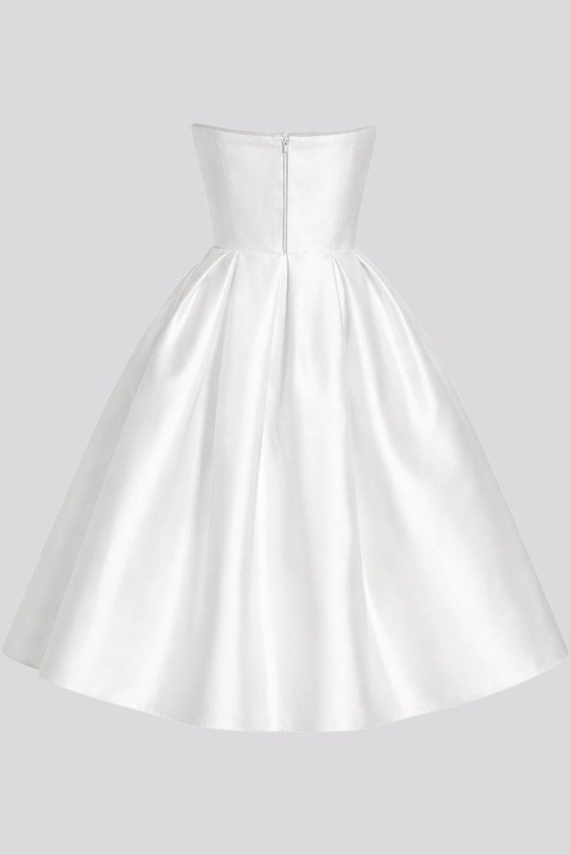 Back view of white strapless satin pleated midi dress on invisible mannequin showing zipper.