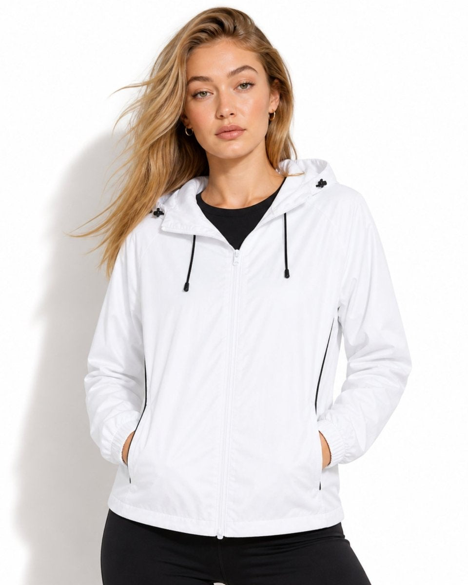 Woman wearing white lightweight hooded windbreaker jacket with black drawstrings zip up front