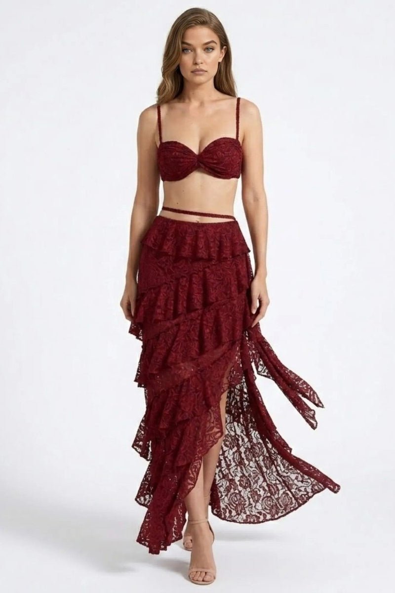 Woman wearing a burgundy lace two-piece outfit on a white background