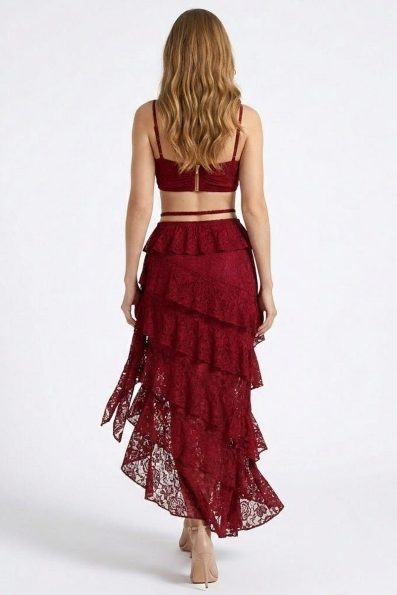 Woman wearing a burgundy lace dress on a white background