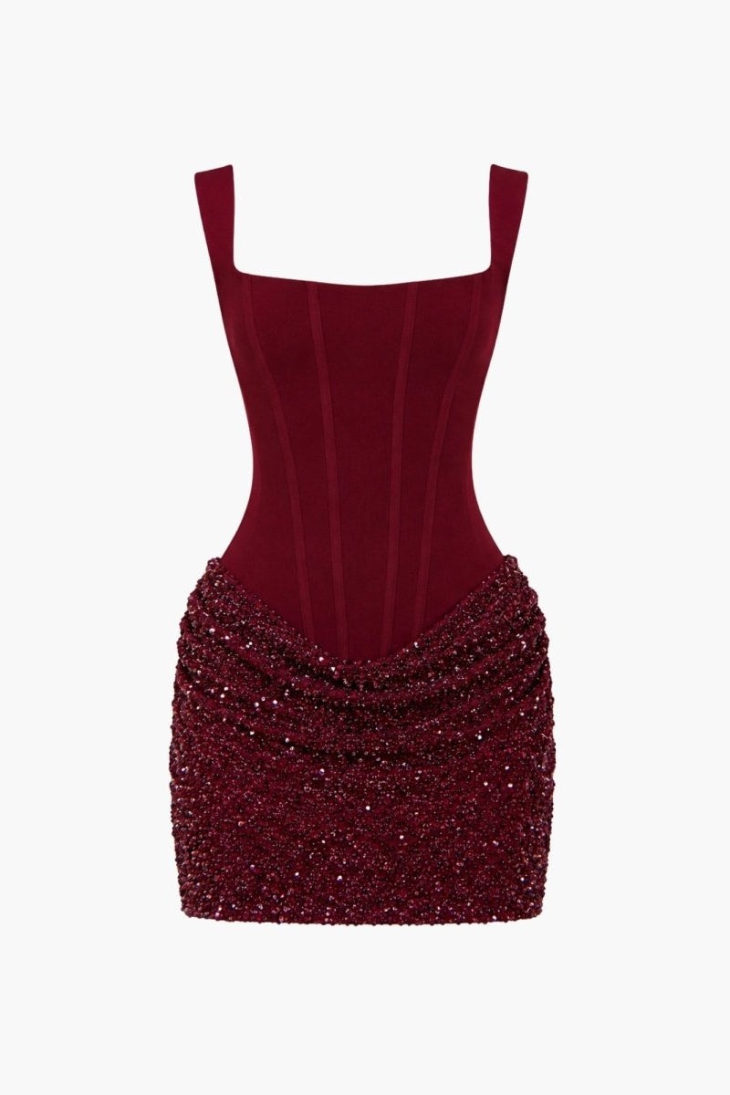 Flat lay product shot of burgundy red square neck corset dress with ruched sparkly skirt.