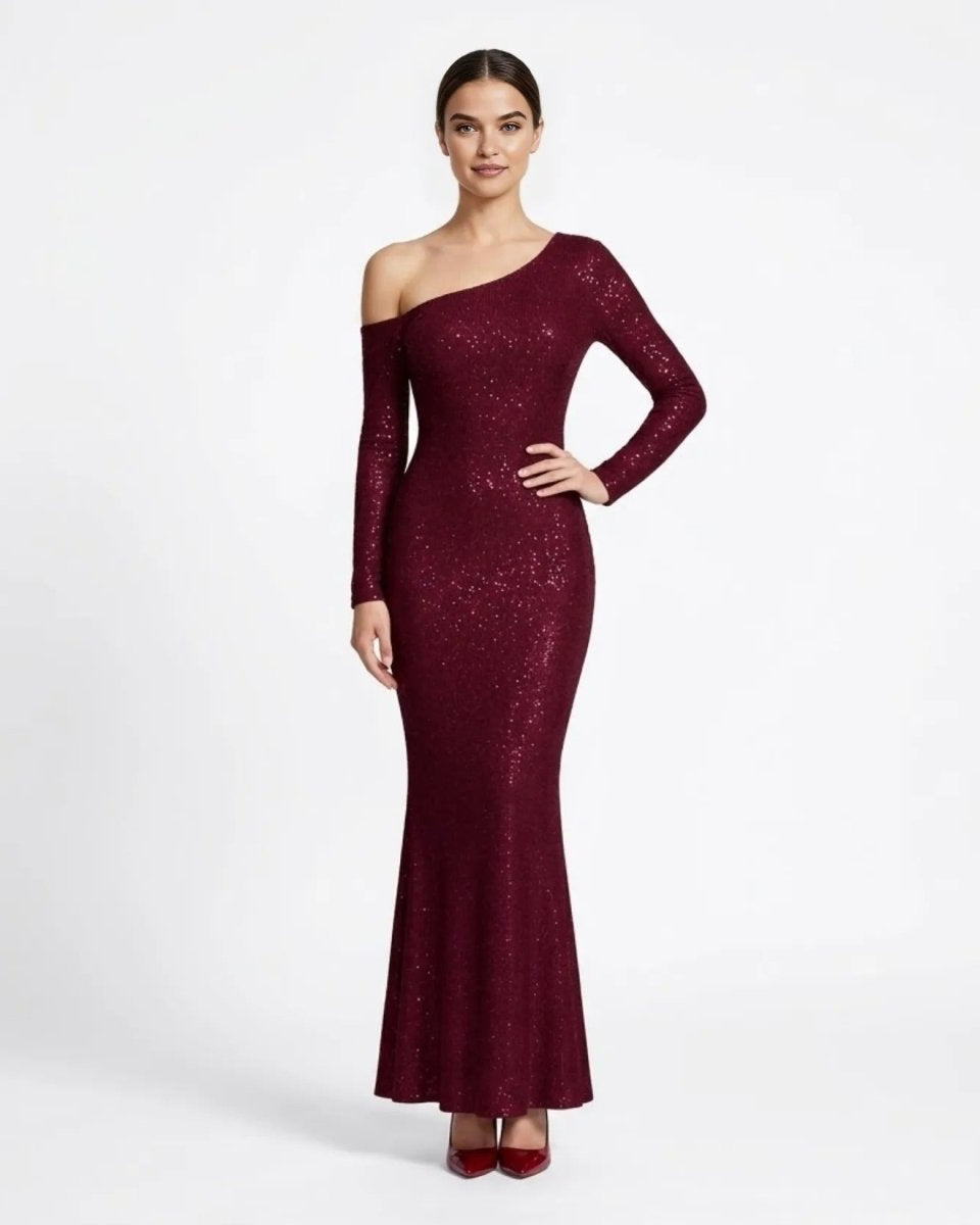 Front view of female model wearing a fitted burgundy sequin one-shoulder long sleeve maxi dress by Fenlo.