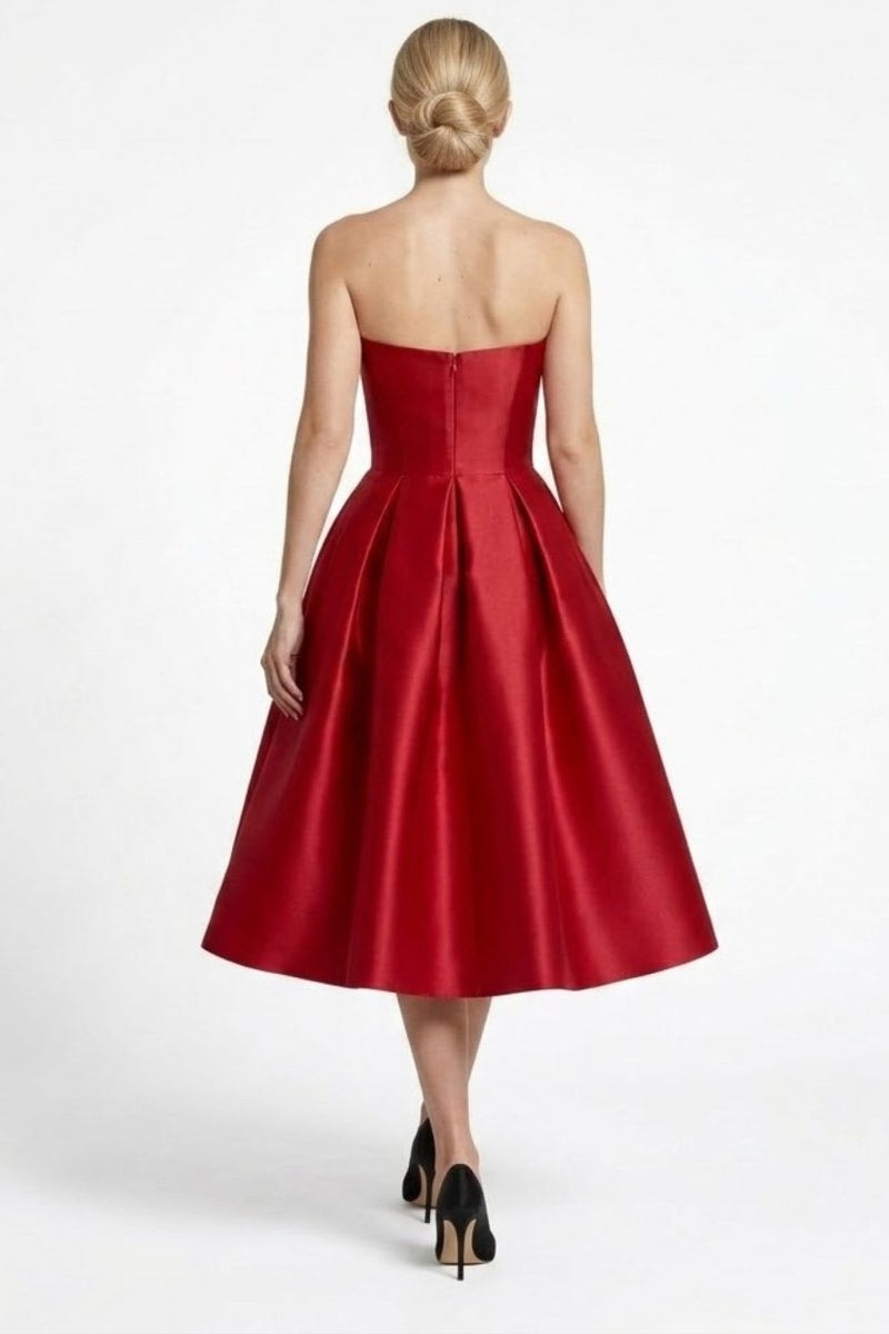 Back view of woman modeling wine red satin strapless midi dress showing invisible back zipper and tailored fit