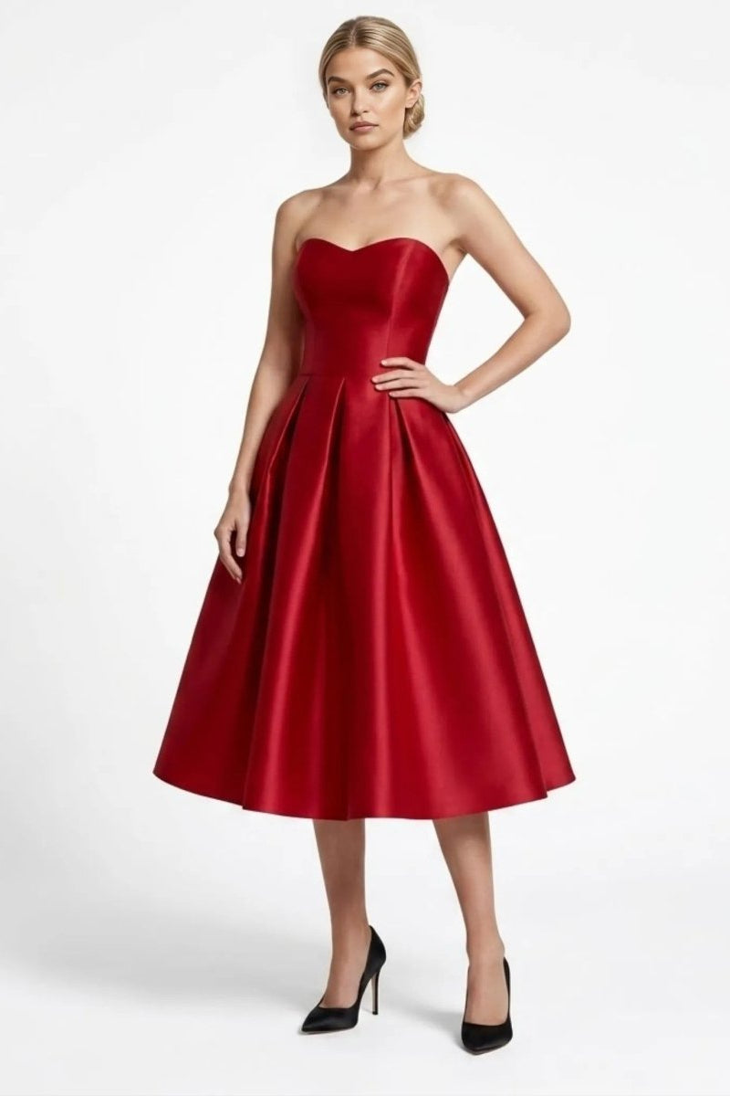 Blonde woman wearing Fenlo Form elegant wine red strapless sweetheart satin pleated midi dress for cocktail party front view