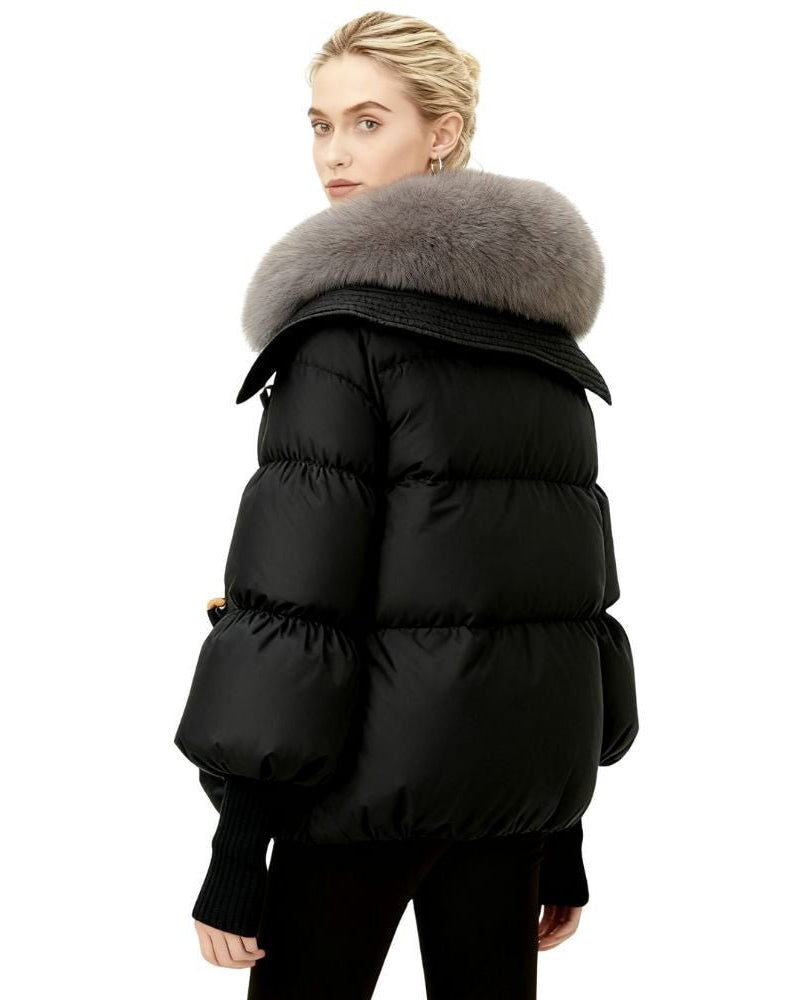 Black fenlo form puffer coat with fur hood worn by a person on a white background