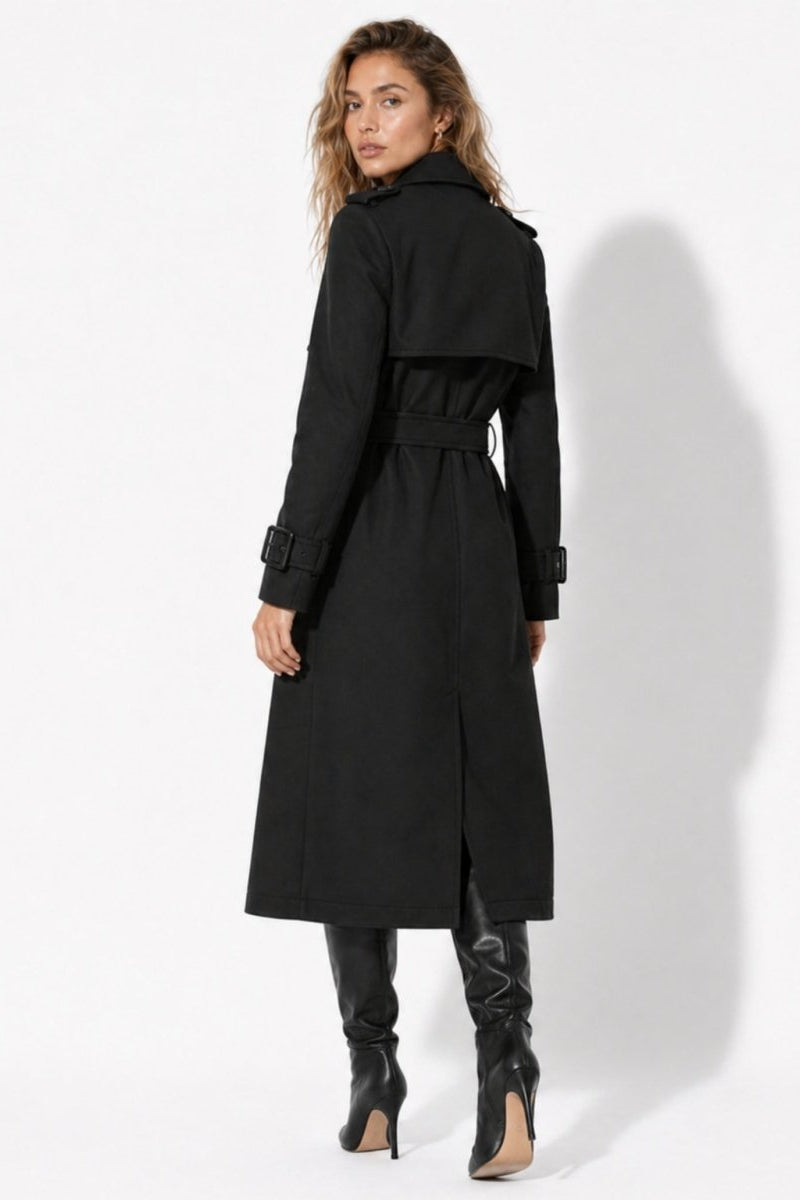 Back view of black trench coat for women showing storm flap and waist belt detail