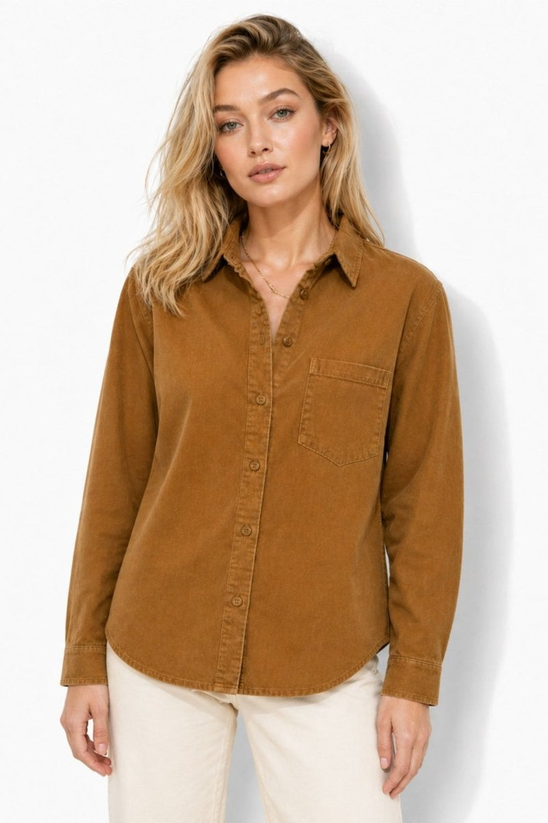 Woman wearing Fenlo Form brown corduroy button down shirt in a relaxed front view, paired with cream casual pants