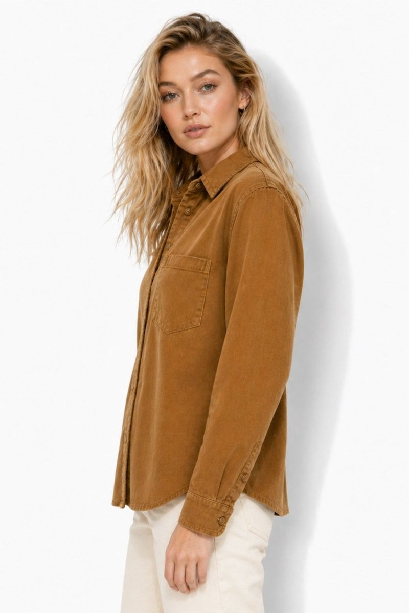 Side profile of the Fenlo Form relaxed fit brown corduroy blouse showing the elegant curved hemline and sleeve drape