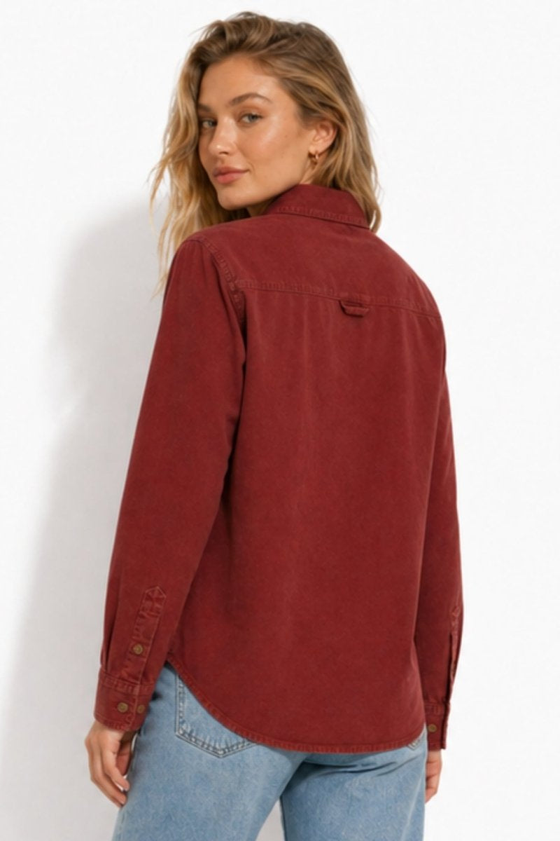 Back view of the Fenlo Form women's fall layering top in red, featuring a back yoke with locker loop detail.