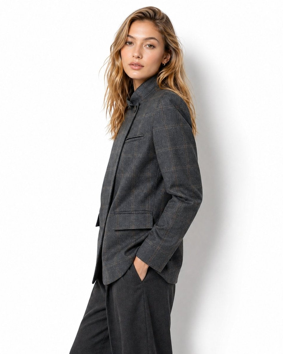 Side profile of female model showcasing the structured fit and windowpane check pattern of the grey blazer.