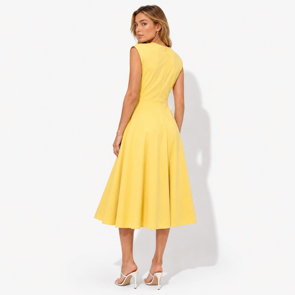 Back view of yellow sleeveless crewneck midi dress showing a seamless concealed zipper and elegant sweeping hemline.