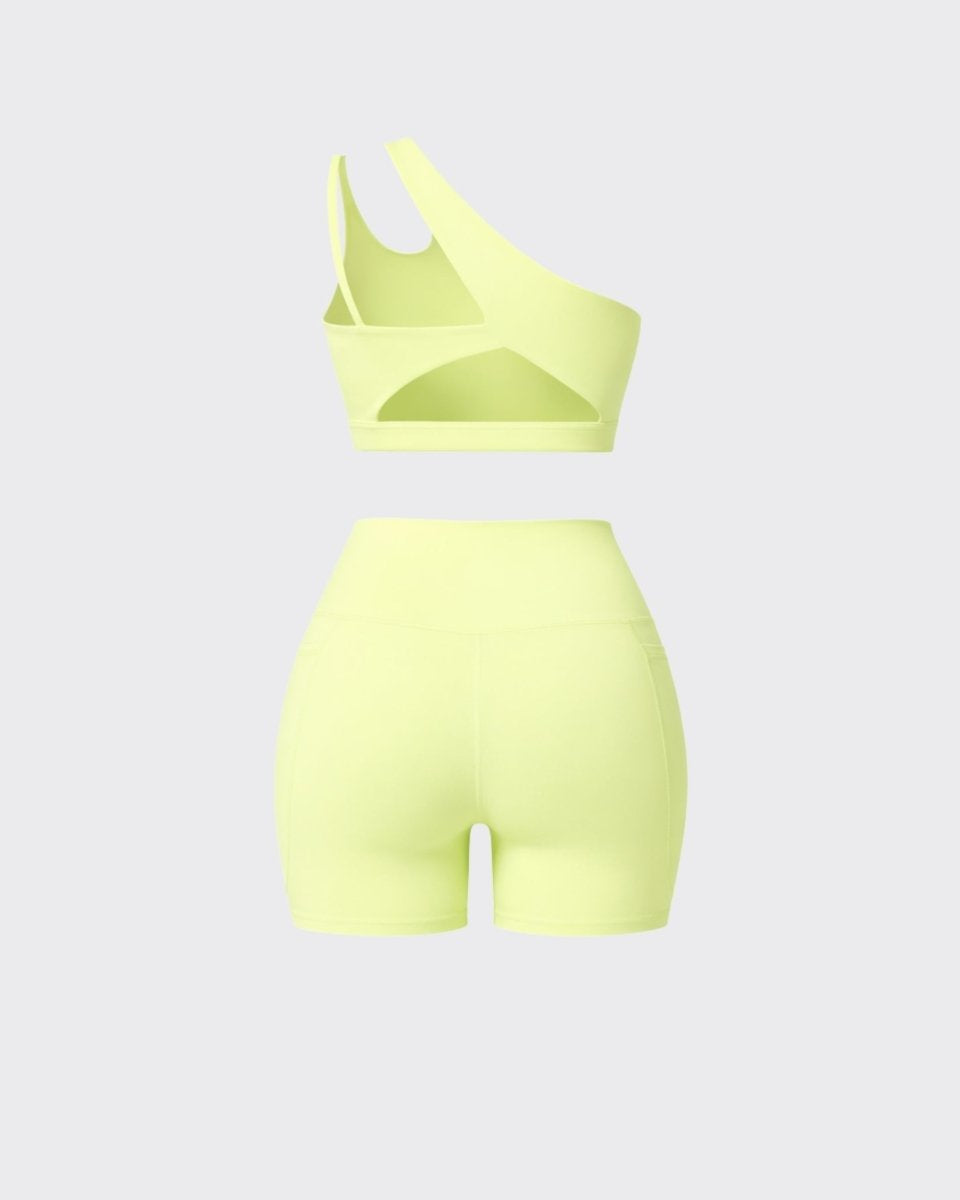 Back flatlay view of yellow two piece workout set detailing back cutouts on crop top