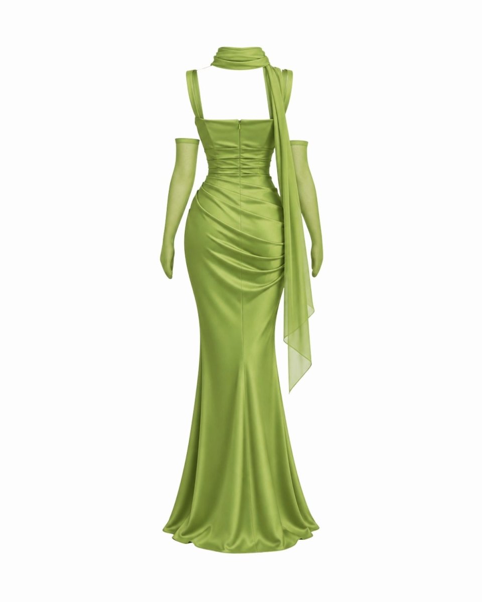 A yellow mermaid gown with a halter-style neckline, long sheer sleeves, and a draped scarf detail, shown on a plain white background.