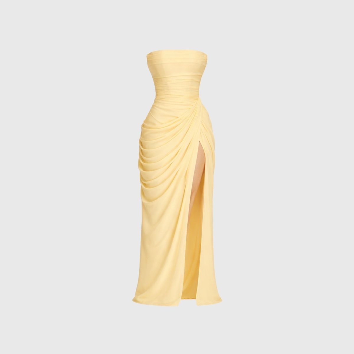 Front flat lay studio view of pale yellow strapless gown with draped waist and thigh slit detail.