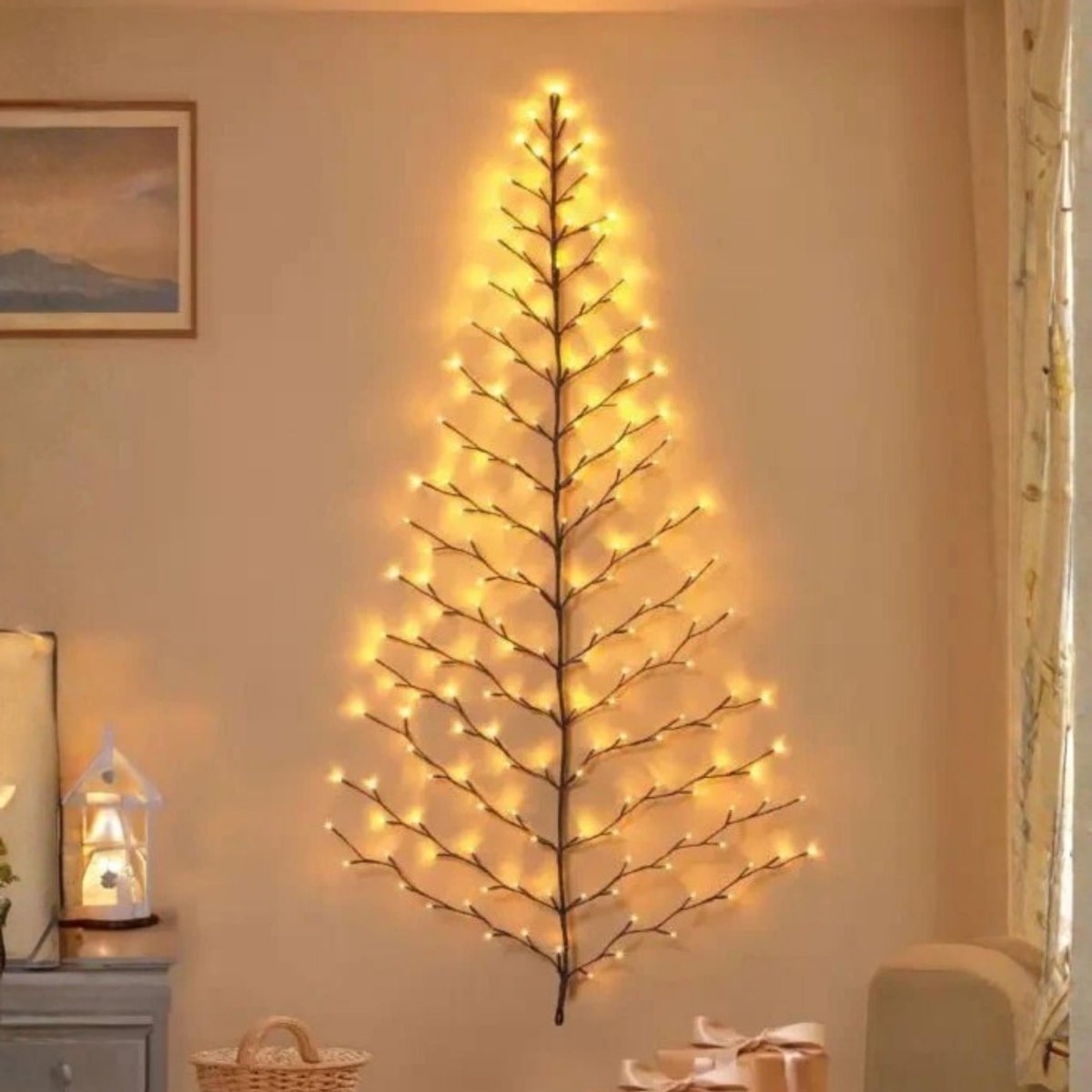 Wall-mounted Christmas tree decoration with lights in a room setting.