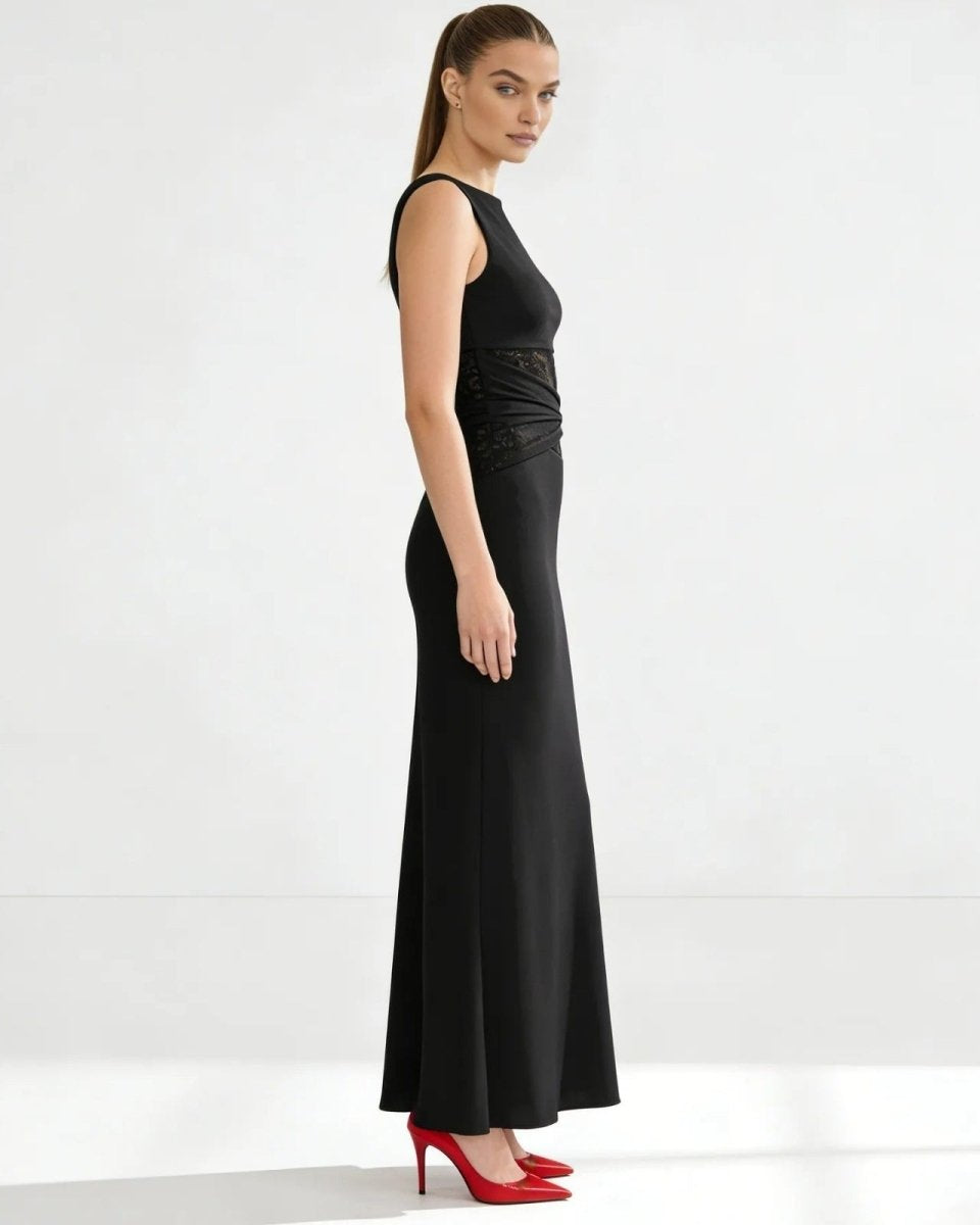 Side profile of a model in the black bodycon midi dress, highlighting the slim fit and below-the-knee length.