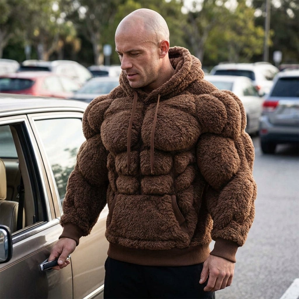 Mirror selfie of a model wearing the Kouvr Titan Sherpa Muscle Hoodie featuring padded six-pack details.
