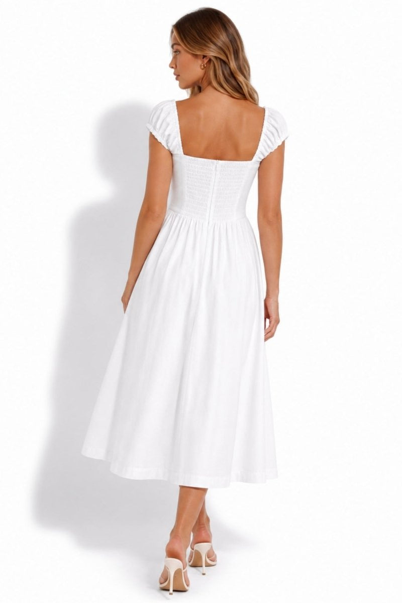A woman modeling a white midi dress from the back, featuring a square neckline, ruffled cap sleeves, a gathered corset-style waist, and a flared skirt, set against a plain white background.