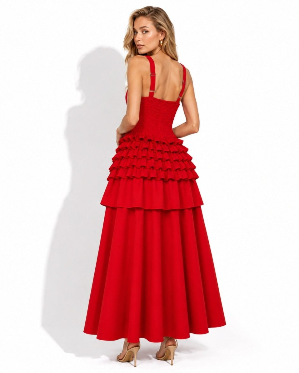 A woman modeling a bright red sleeveless maxi dress with a tiered ruffle skirt and thin shoulder straps, shown from the back against a white studio background.