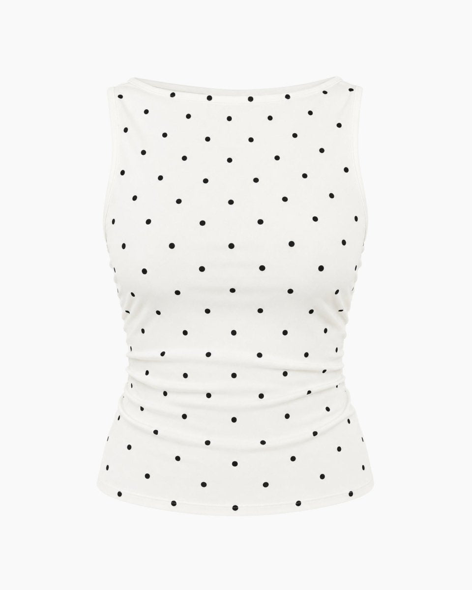 A sleeveless white tank top with a black polka dot pattern, shown against a plain white background.