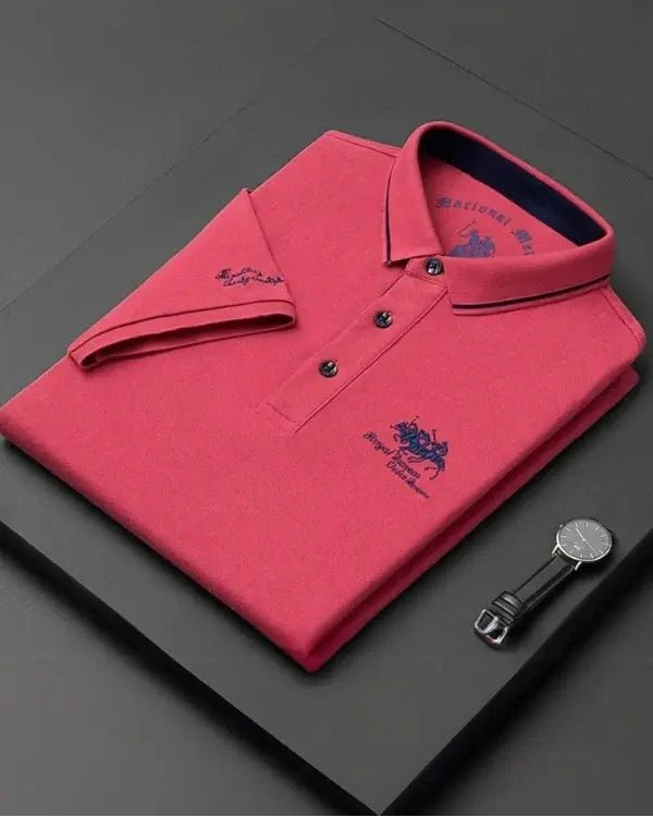 Pink polo shirt with brand logo on a dark surface