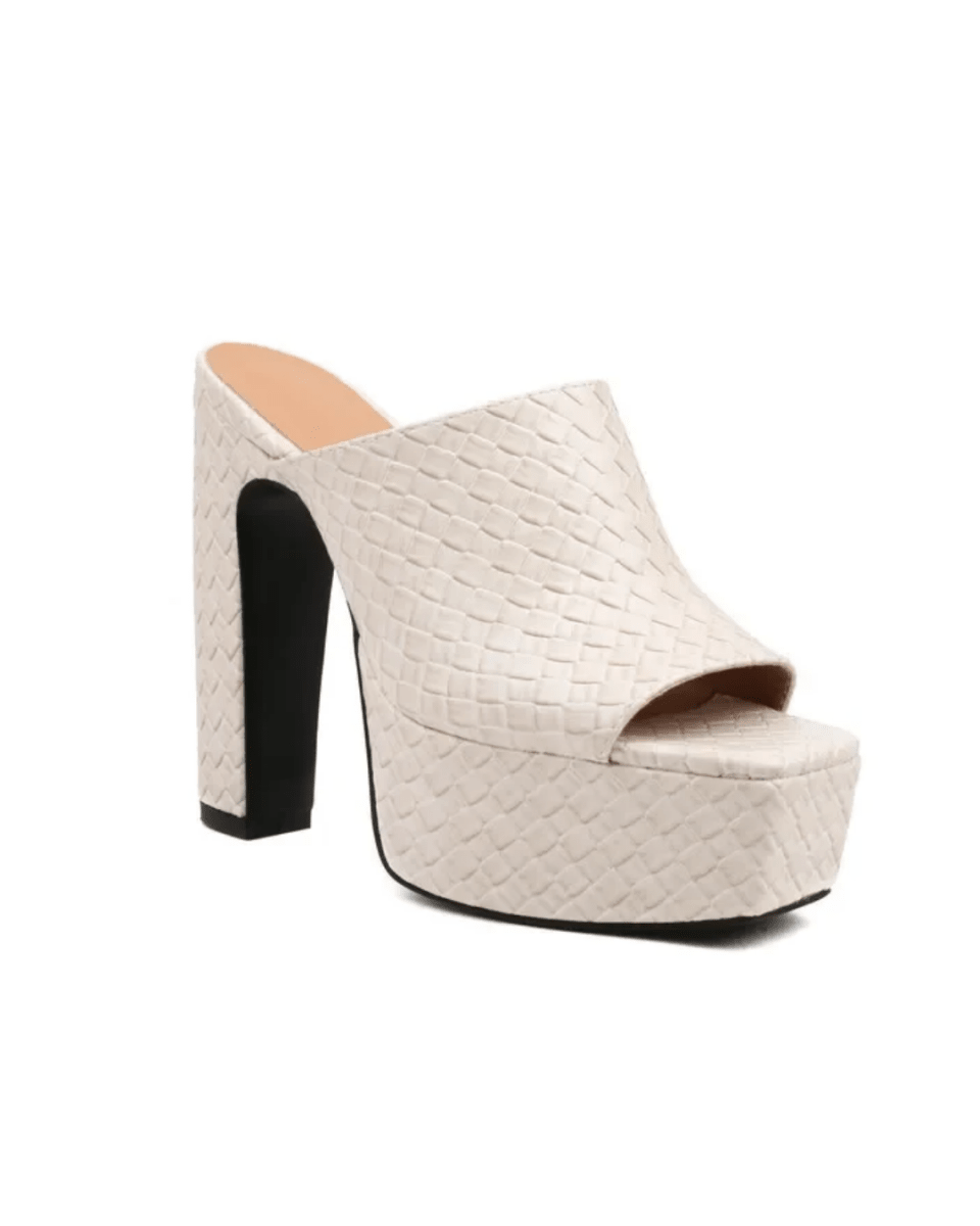 A single platform mule sandal with a high block heel, featuring a woven leather upper in a light cream color with a black outsole and heel accent.
