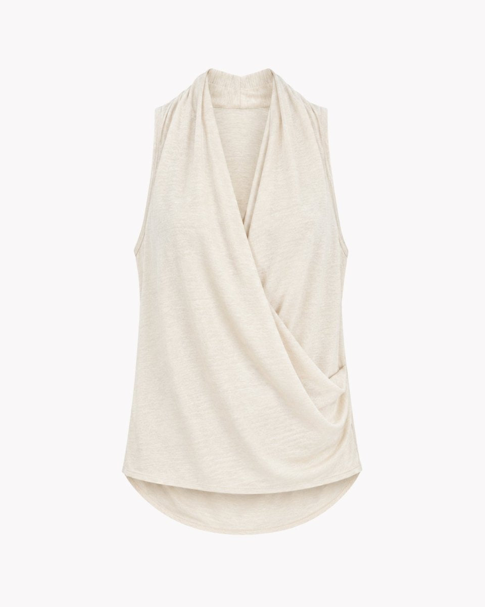 Studio flat lay front view of a sand colored draped wrap tank top highlighting the luxurious fabric texture and crossover design details.