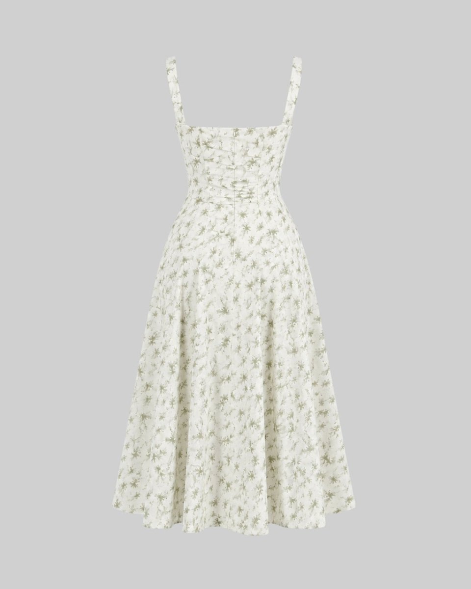 A sleeveless A-line midi dress with a small green and white floral print, featuring thin shoulder straps and a gathered bodice, shown against a solid gray background.