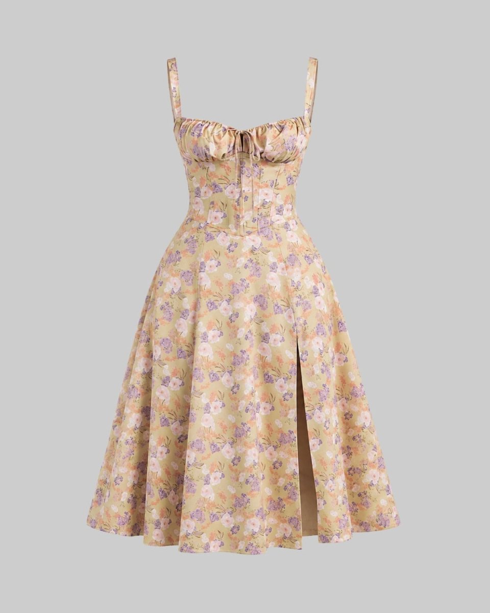 A retro-style A-line midi dress with a beige and yellow floral pattern, featuring a sweetheart neckline, thin shoulder straps, a gathered corset-style bodice, and a front slit.