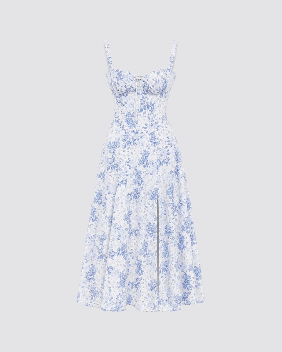 A sleeveless white midi dress with a blue floral pattern, featuring thin spaghetti straps, a sweetheart neckline, and a flared A-line skirt, shown against a solid light gray background.