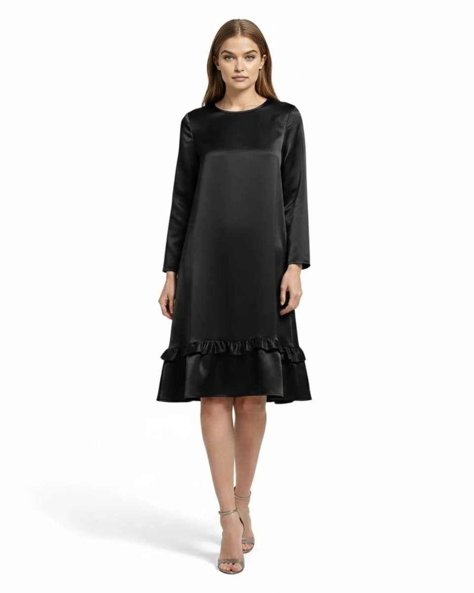 Model wearing the Adalee black satin long sleeve midi dress with a ruffle hem, front view.