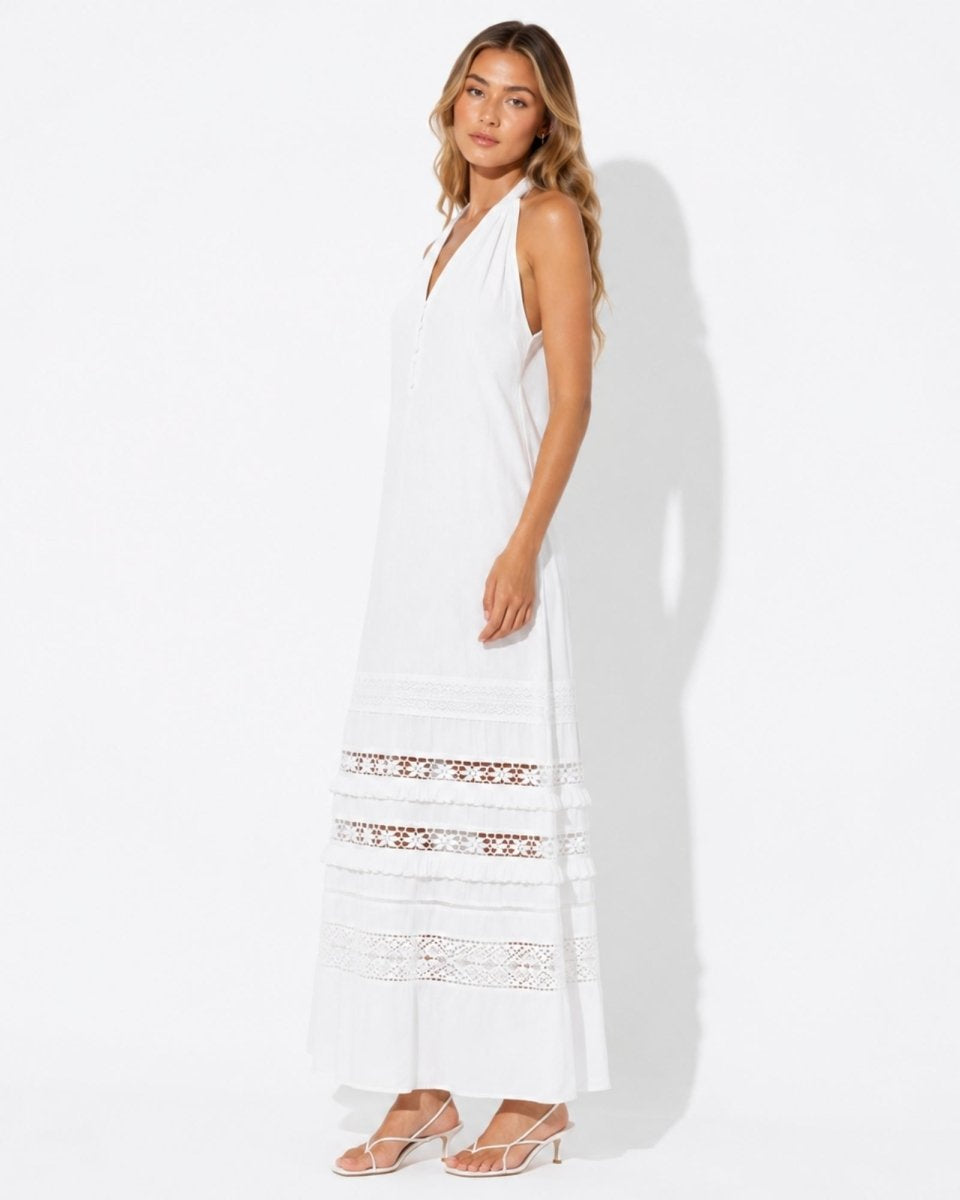 Side view of the elegant white sleeveless summer maxi dress showing sheer lace panel details and drape.