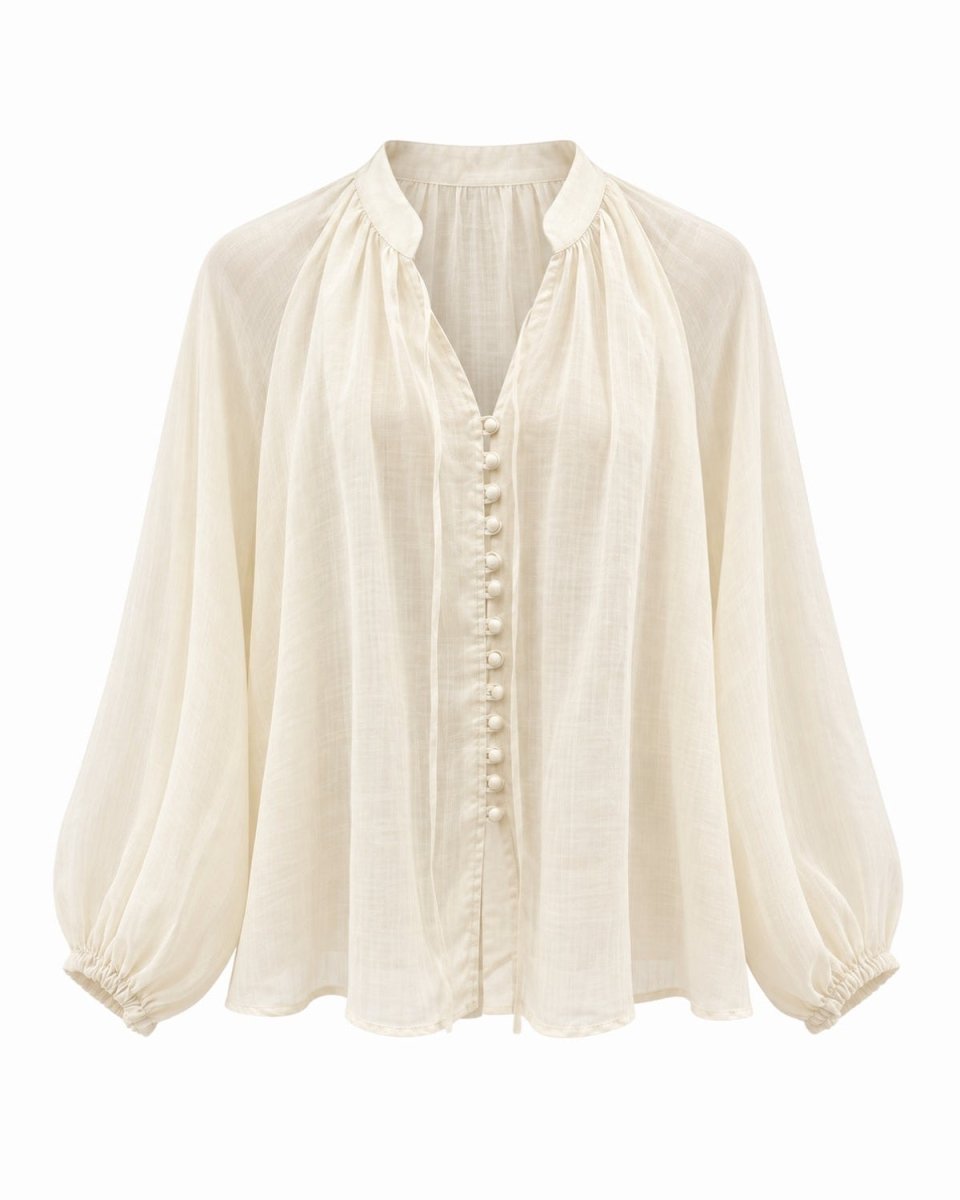 An apricot long-sleeve blouse with a gathered high collar, a button-down front, and elasticized cuffs, shown against a plain white background.