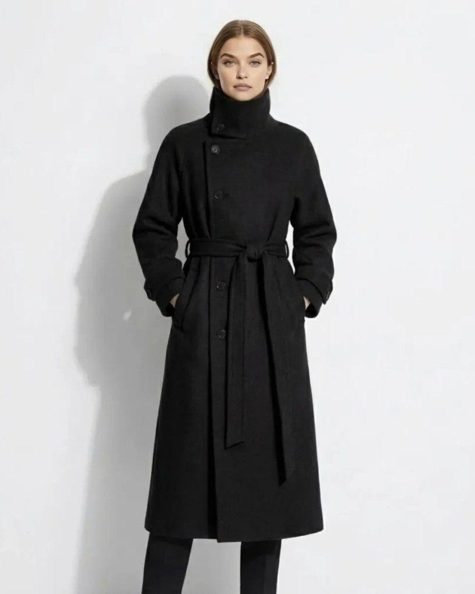 Model wearing the Ashley long black belted wool coat with a high funnel neck, viewed from the front.
