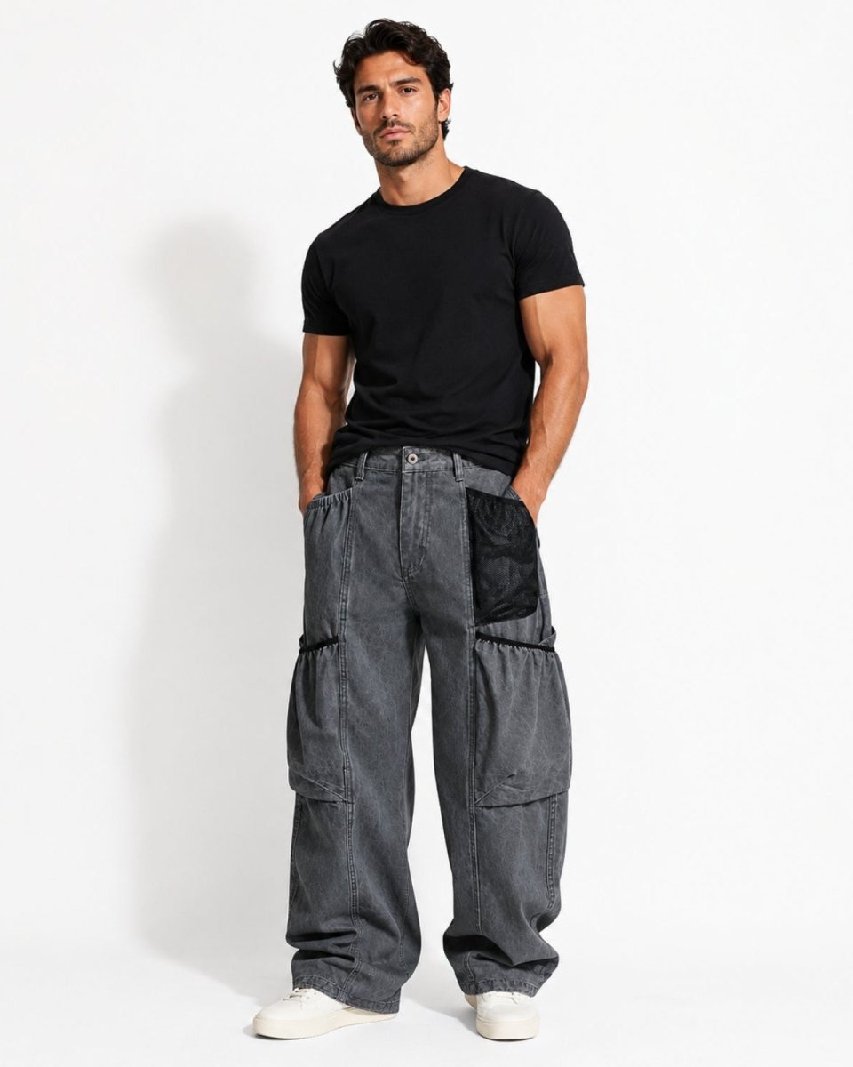 Front view of baggy wide leg washed grey denim cargo pants featuring Y2K oversized streetwear fit and black mesh utility pocket.