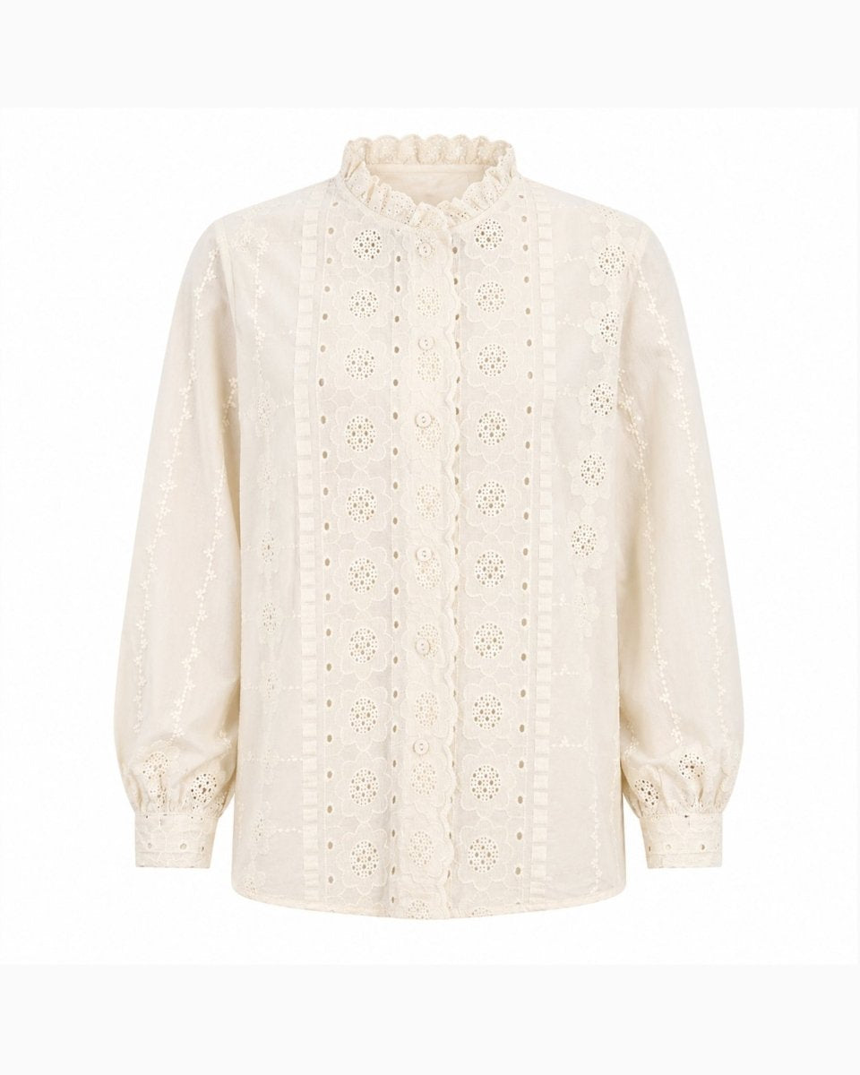 Front view product shot of an unstyled beige broderie anglaise women's blouse featuring scalloped button placket and puff sleeves.