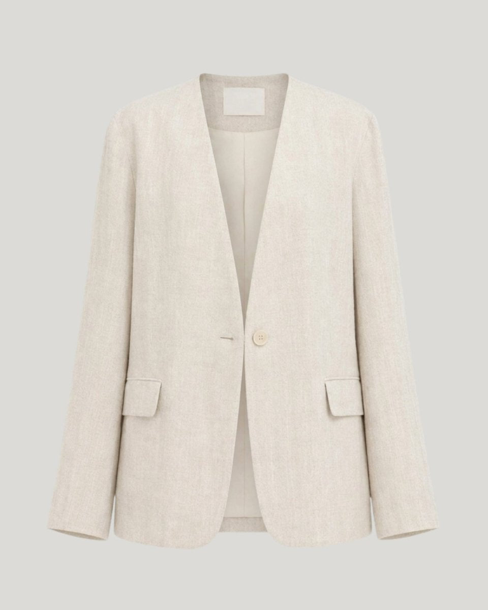 Flat lay ghost mannequin view of a beige collarless v-neck suit jacket showing front button details.