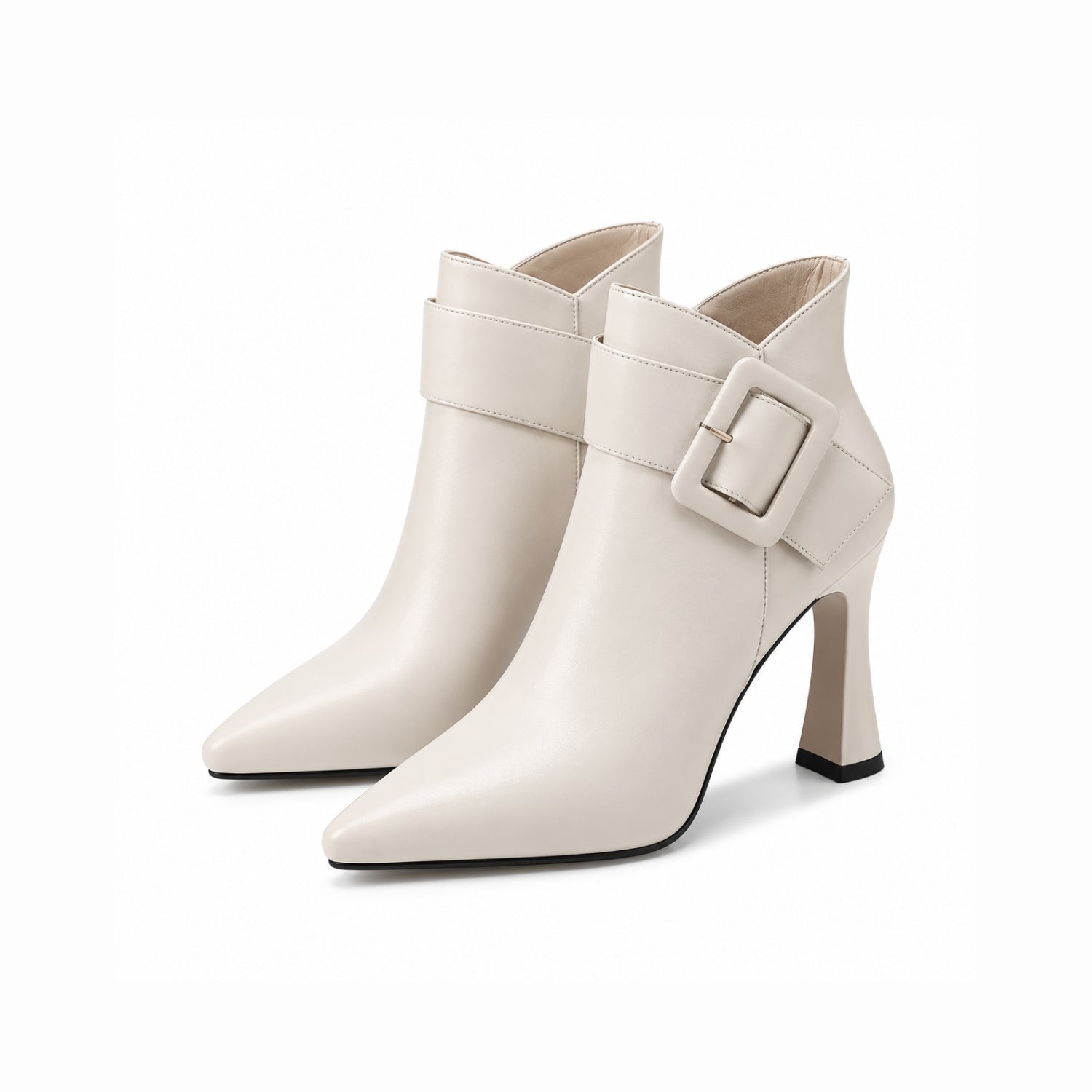 Close up of women's cream pointed toe ankle boots featuring an architectural flared heel and oversized buckle