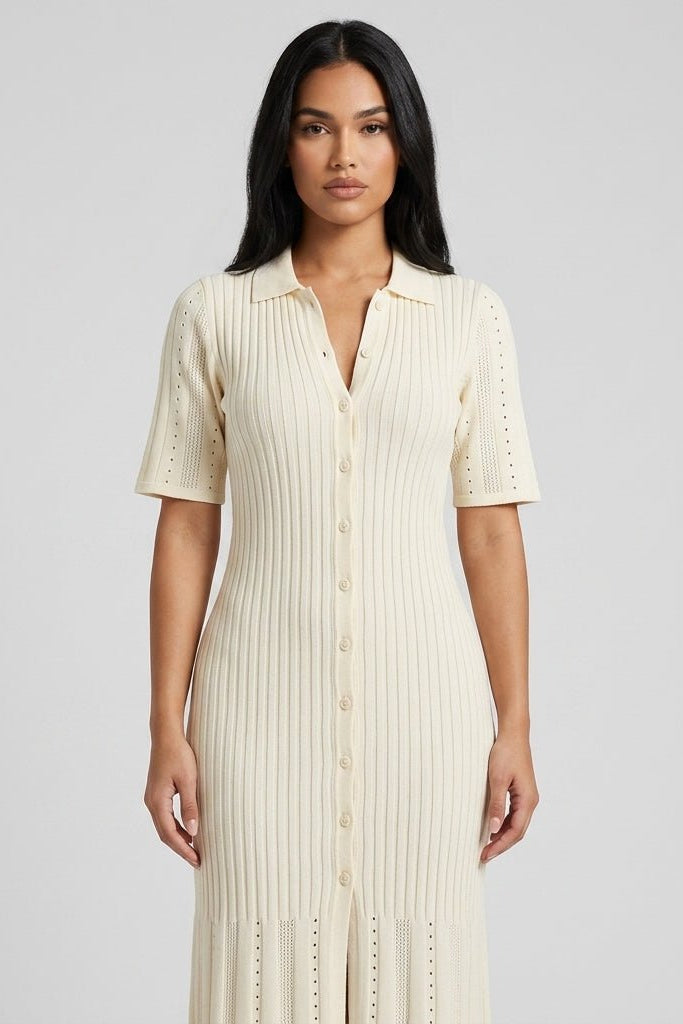 Close up of Fenlo Form beige knit polo dress showing v-neckline, front buttons, and diamond pointelle stitching.