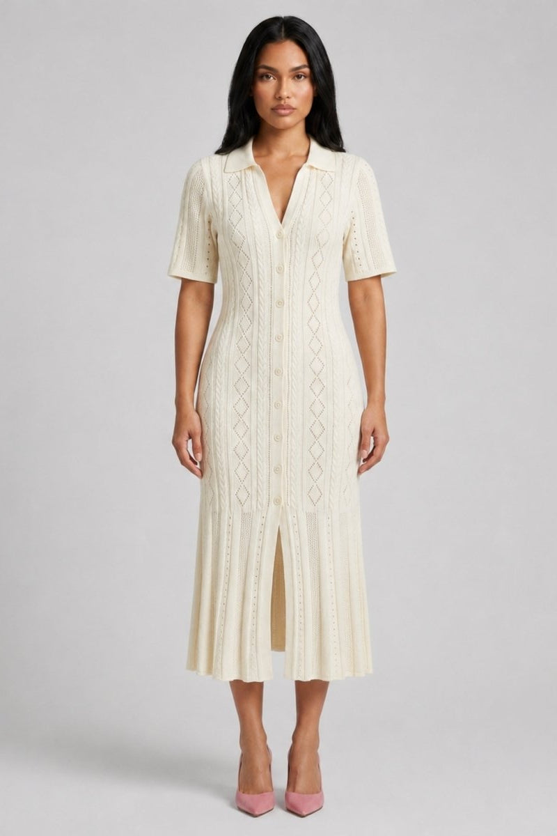 Woman wearing Fenlo Form cream ribbed knit button down polo midi dress with flared hem facing forward.